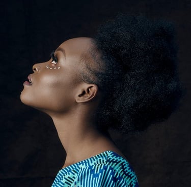 A black woman in blue and white shirt