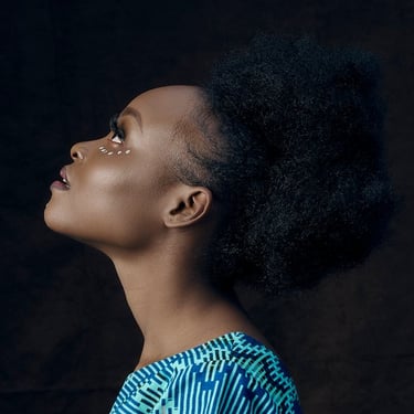 A black woman in blue and white shirt